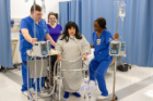 "Dr. Linda Steeg graciously donned the hospital gown and equipment of an ICU patient to demonstrate the interprofessional roles dealing with mobility of critically ill patients in the ICU. The classroom activity involved all senior-level nursing students in NSG 478 and a class of Physical Therapy students. Although the photo was captured in Wende's 4th-floor skills lab and involve a nursing student and a friend, the image was used to demonstrate how professionals can work collaboratively to achieve positive patient outcomes." Submitted by Janice Jones.