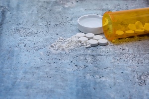 Prescription pill bottle with white tablets. 