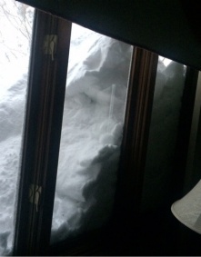 snow piled against a window. 