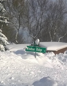 street sign buried in snow. 