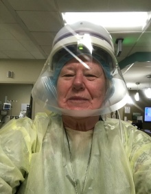 SON alumni wearing a mask, gown and other PPE in a clinical setting. 
