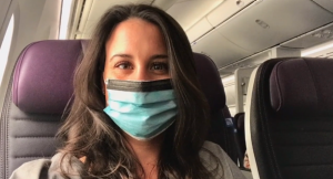 A nurse wearing a mask on an airplane. 