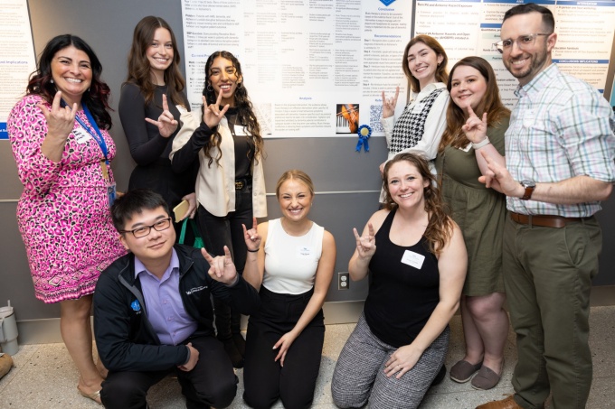 Students posing with first place research poster. 