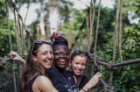 From left, UB School of Management PhD candidate Emily Campion, Claudia Ludmila Blankson of Ghana, and UB MD/MBA student Claire Cowden stand on a canopy walkway high above Kakum National Park. Photo: Anthony Falvo