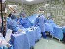 Several doctors and nurses in operating room. 