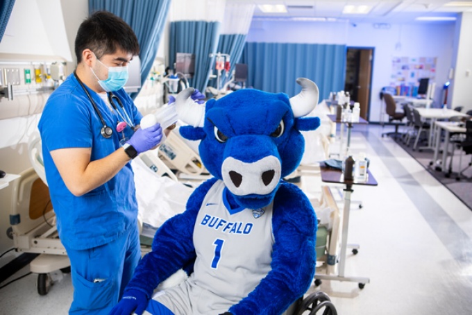 nursing student with mascot. 