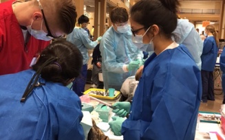 nursing and dental students examining patient. 