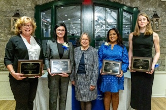 Award recipients posing with plaques. 