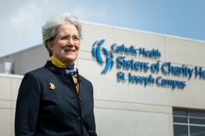 Alumnia Rebec Rebecca McCormick-Boyle standing in front of St. Joseph's hospital. 