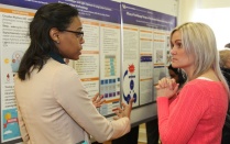 Student explaining research poster. 